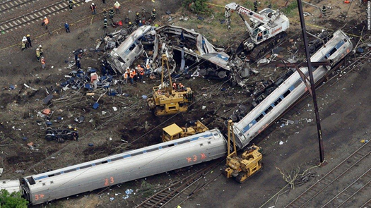 Figure 2. Two passenger cars on their side and the remains of a damaged passenger car