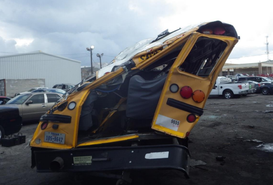 View of the rear of the HISD bus showing contact damage to the top left corner.
