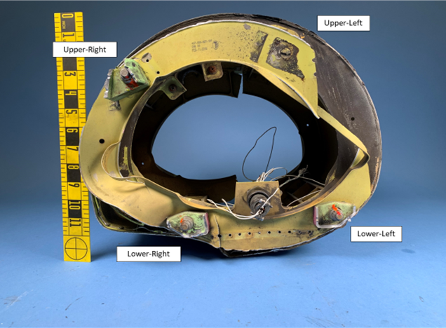 Tail boom with fractured remains of attachment fittings. Upper-left attachment hardware (bolt, nut, and washers) was not present