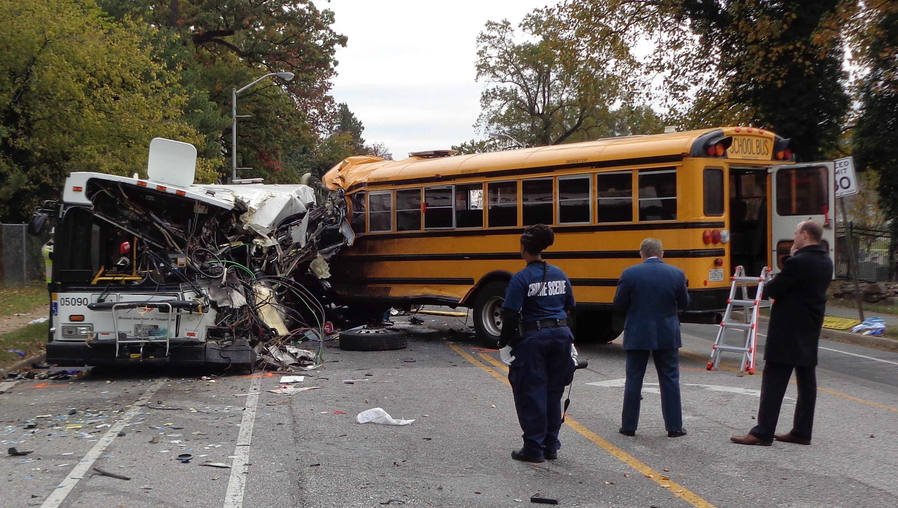 Final rest position of buses, looking east on Frederick Avenue. The damaged transit bus is shown at the left. The school bus is 