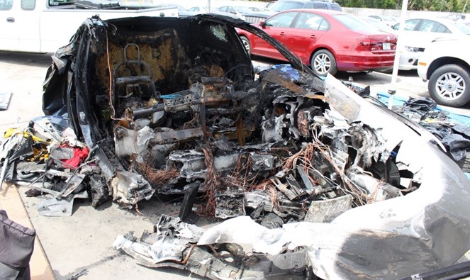 Photo of the remains of Tesla Model S at storage yard.