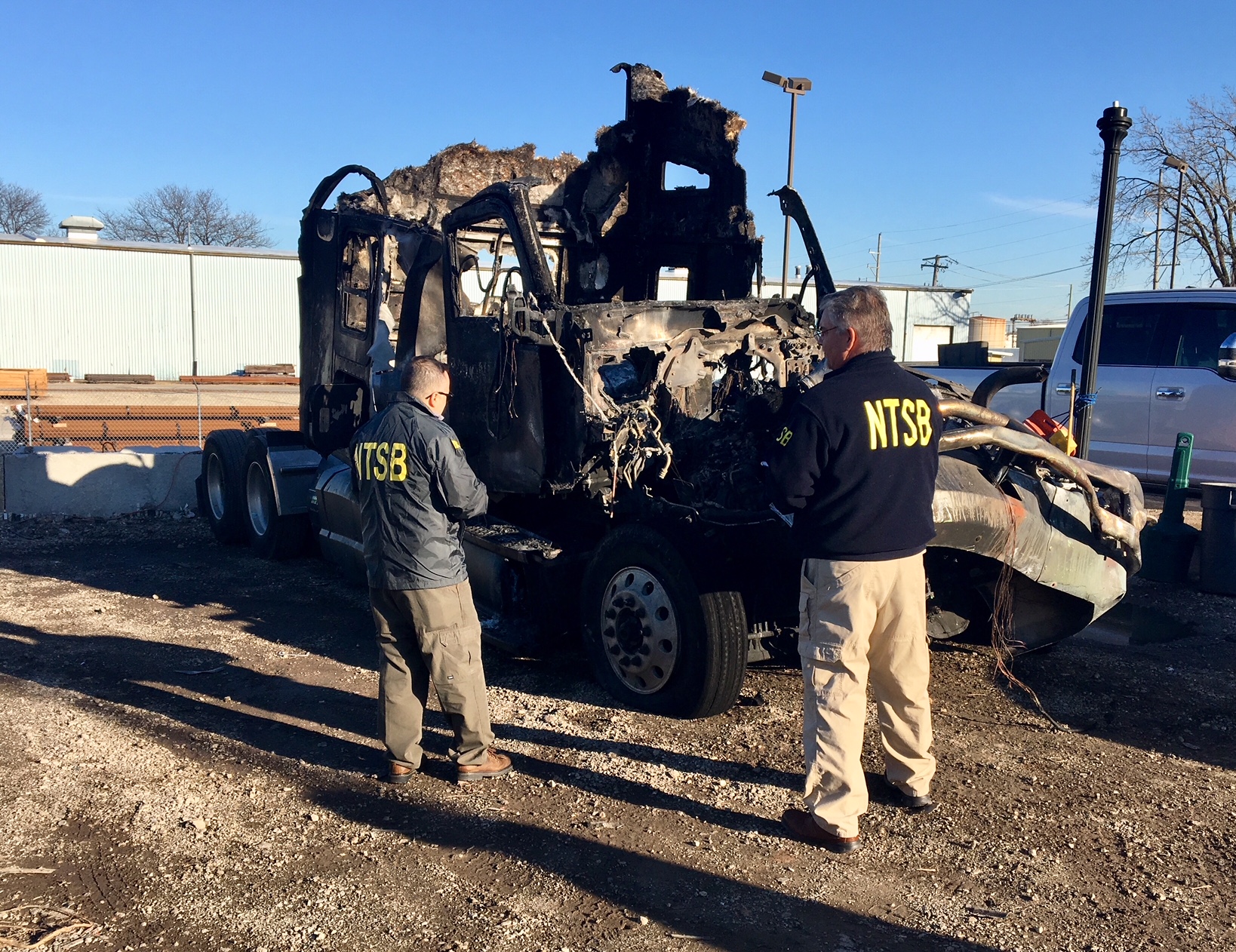 NTSB investigators examining the damaged and burnt 2016 Kenworth truck-tractor (the Pioneer truck