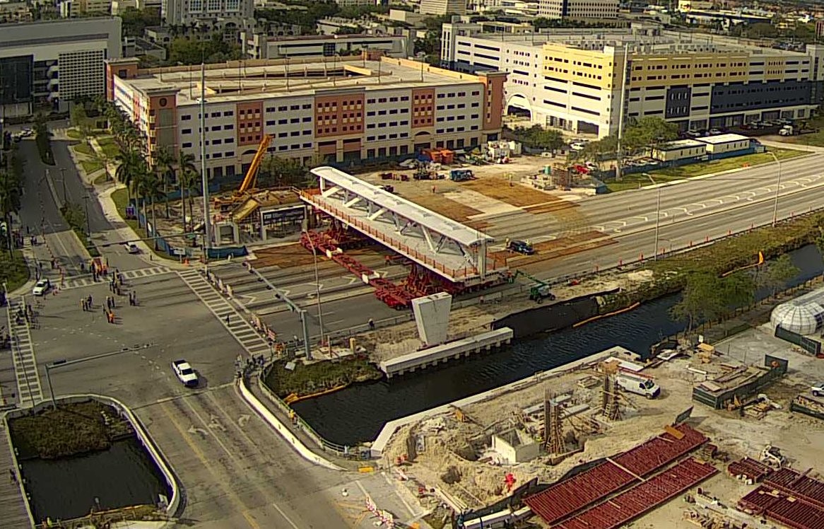 Figure 2. View of transporters moving the pedestrian bridge into place on the bridge piers.