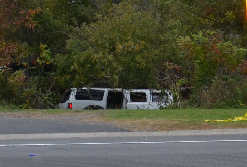 Photo of crash-involved 2001 Ford Excursion stretch limousine at final rest in the ravine.