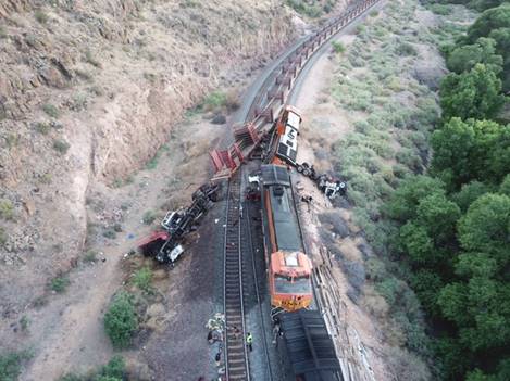This photograph is an aerial view showing the two trains that collided. The trains are on a right-hand curve. The lead locomotiv