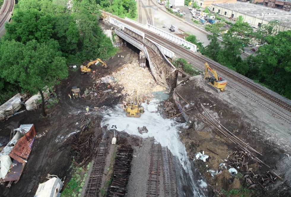 NTSB drone aerial photograph of damaged bridge and debris.