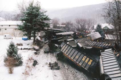 Photo of pileup of derailed coal cars.