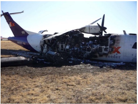 Right side of fuselage showing extensive fire damage to right wing and flap  components. 