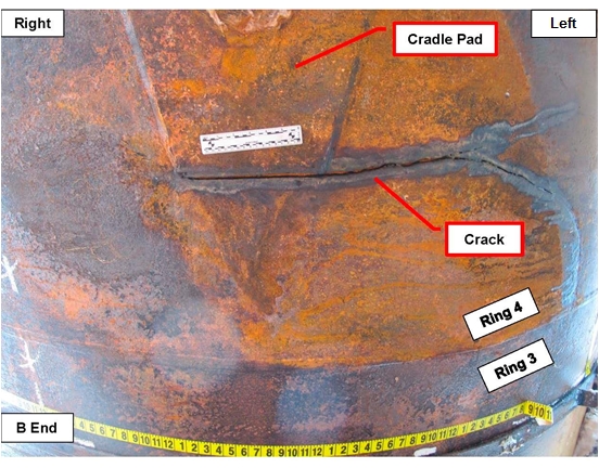 Photo of the exterior surface of tank car bottom showing circumferential crack inboard of cradle pad.
