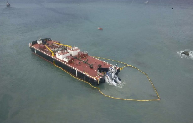 An oil containment boom was deployed around the ATB following the grounding. (Photo by  Canadian Coast Guard)