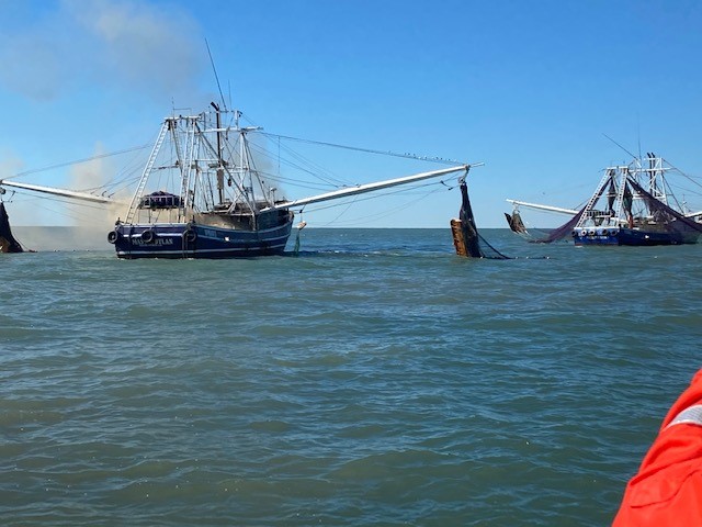Photo of Master Dylan grounded on a sandbar after being towed by the Master Dustin II.