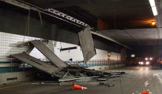 Postaccident scene with the crushed passenger car barely visible under the wreckage.