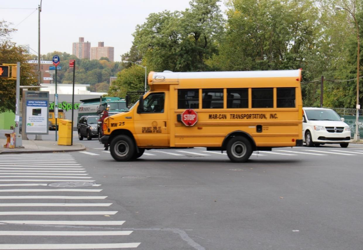 Photo of school bus similar to that involved in crash, at crash intersection.