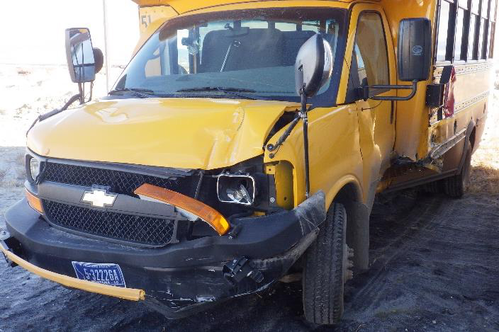 Left-front and partial side view of school bus postcrash.