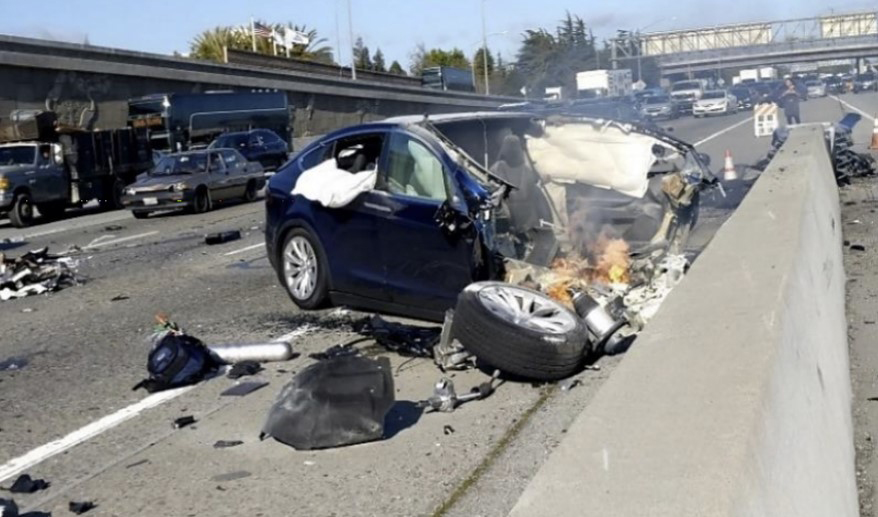 Photo of Northbound view of the crash scene before the Tesla was engulfed in flames.
