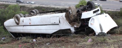 The motorcoach in final rest position on embankment adjacent to Interstate 15 near Pala Mesa, California. (Photo by California H