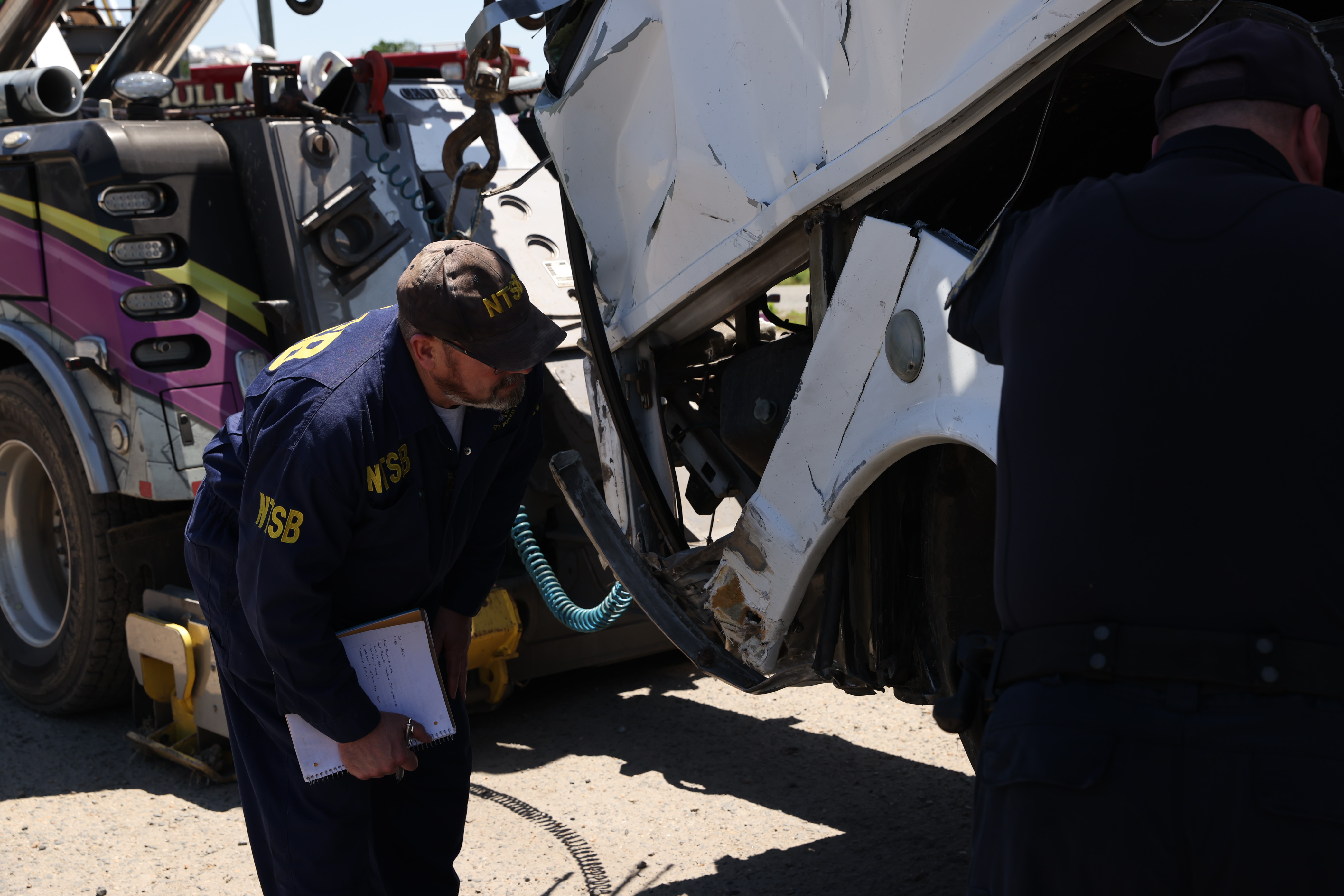NTSB investigators examine the motorcoach involved in the May 29 multivehicle collision in Stafford, Virginia.