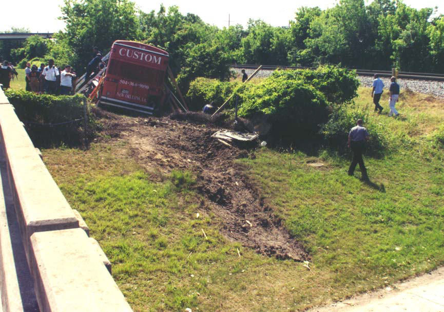 Rescue workers attempt to stabilize the bus in its final resting position.