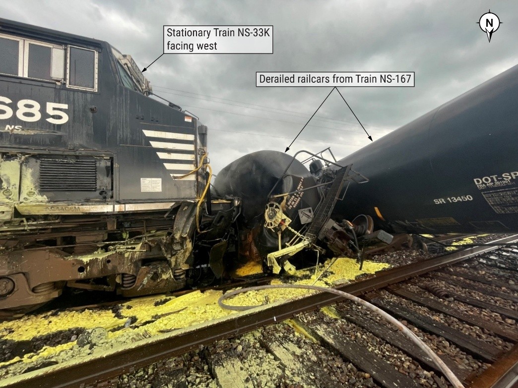 The stationary NS-33K westbound locomotive and derailed tank cars from NS-167.