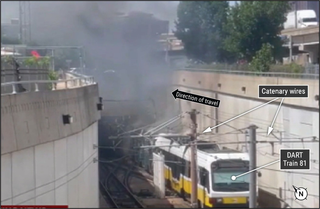 Photograph depicting DART Train 81 at the forefront and fire and smoke at the back of the photograph.