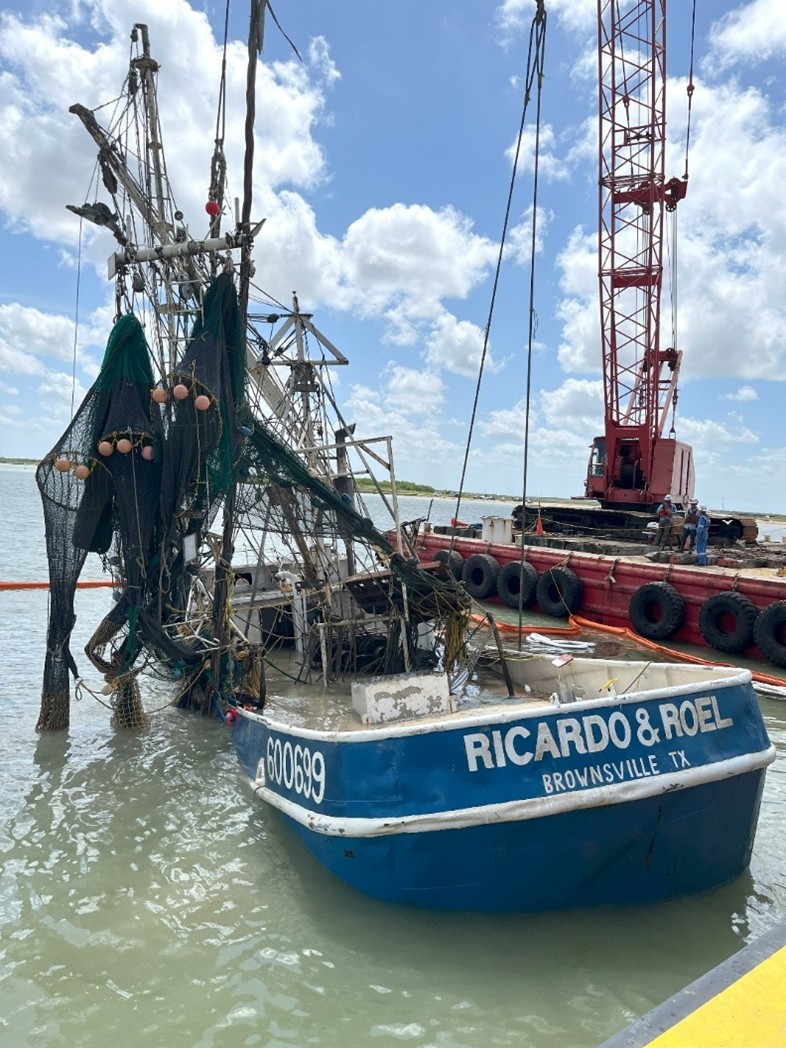 The partially submerged Ricardo & Roel being raised during salvage operations on July 17, 2025