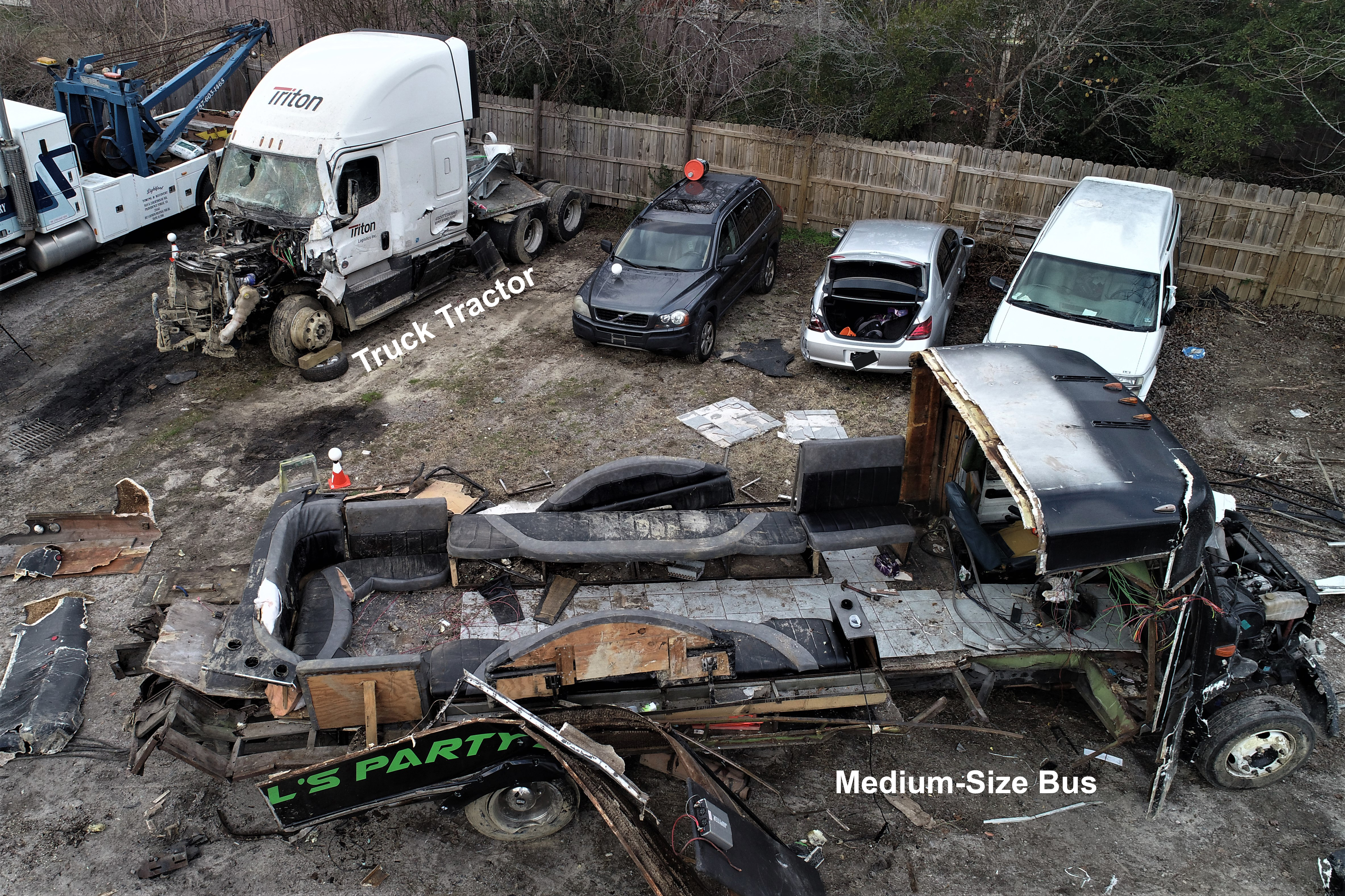 An elevated view showing both vehicles after they had been removed from the crash scene and taken to a tow yard. The medium-size