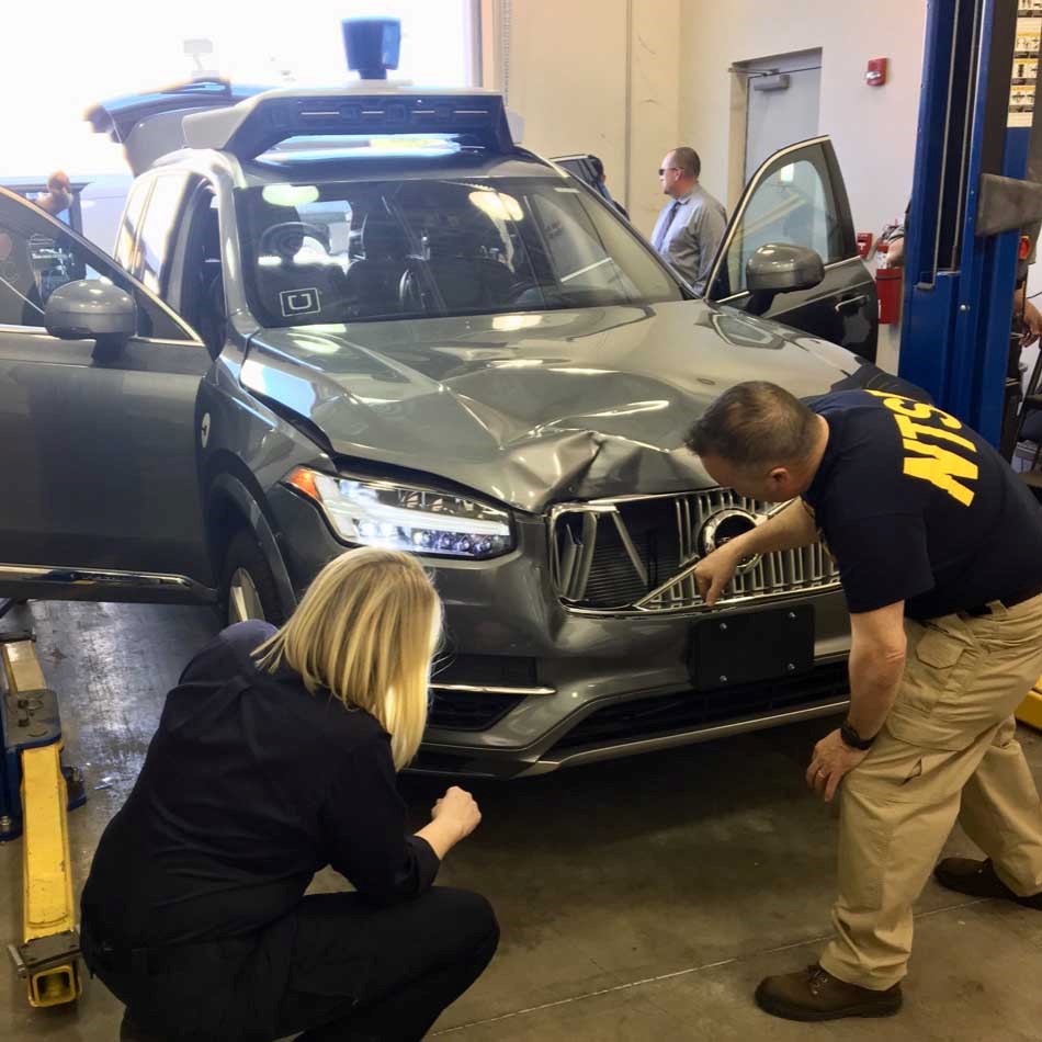 NTSB investigators on-scene in Tempe, Arizona, examining the Uber automated test vehicle involved in the collision. 