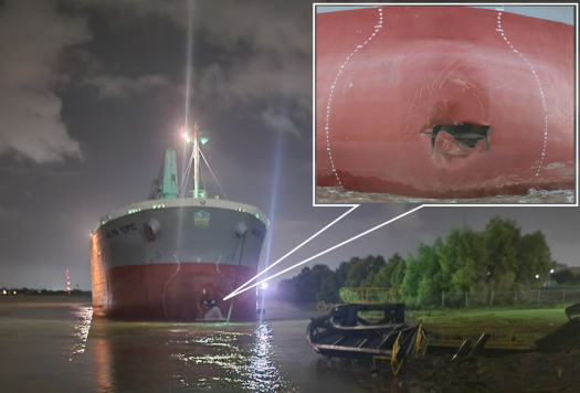Jalma Topic downriver of the office barge with its port anchor out following contact. Inset shows a close-up of the damage to th