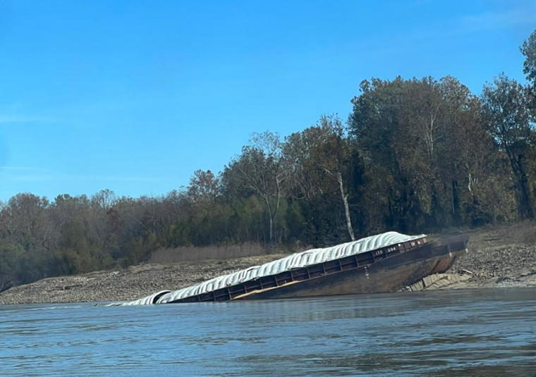 A barge that grounded and partially sank following the Marquette Warrior’s loss of steering. 
