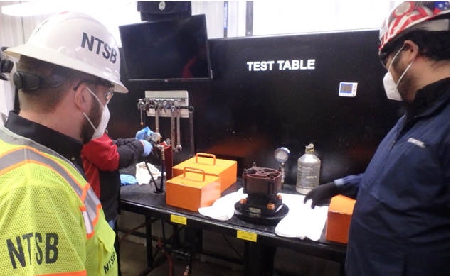(In this photo taken on March 15, Investigators conducting a start-to-discharge pressure test on a pressure relief valve, NTSB S